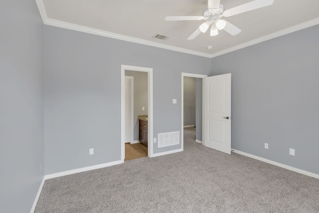 unfurnished bedroom with ceiling fan, ensuite bath, light carpet, and crown molding