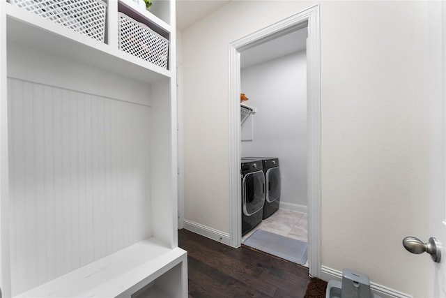 laundry room featuring dark hardwood / wood-style floors and washing machine and clothes dryer