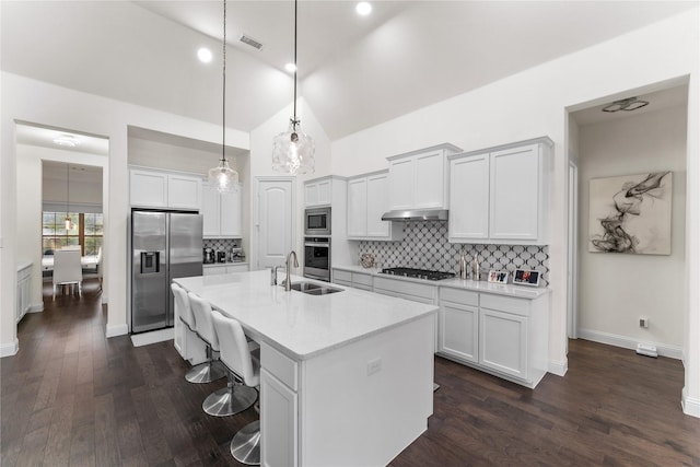 kitchen featuring white cabinetry, sink, hanging light fixtures, an island with sink, and appliances with stainless steel finishes