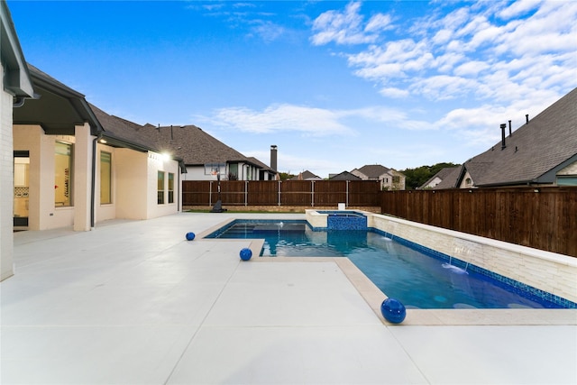 view of pool with pool water feature, a patio area, and an in ground hot tub