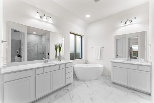 bathroom featuring vanity and shower with separate bathtub