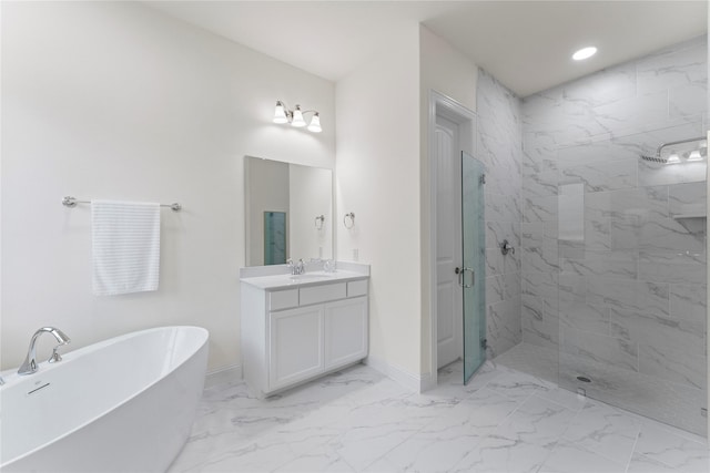 bathroom featuring a stall shower, marble finish floor, a freestanding bath, and vanity