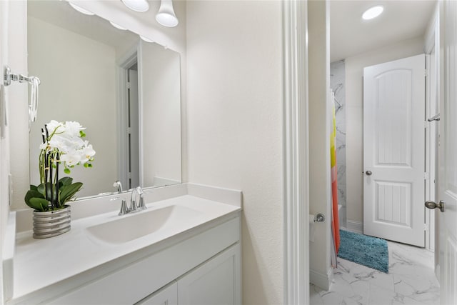 full bath featuring marble finish floor, vanity, and a shower with shower curtain