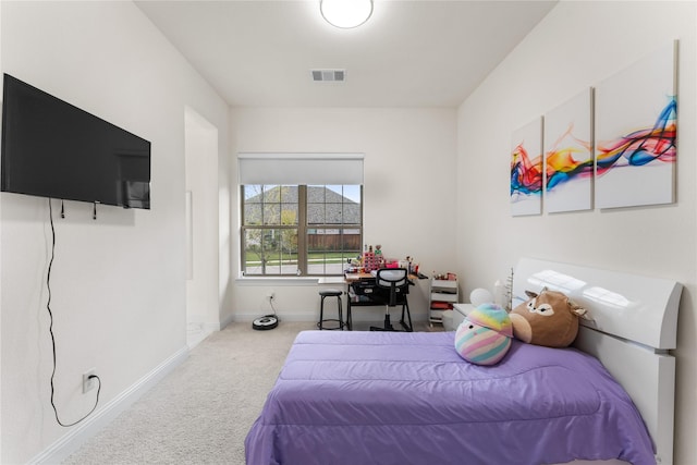 carpeted bedroom with visible vents and baseboards