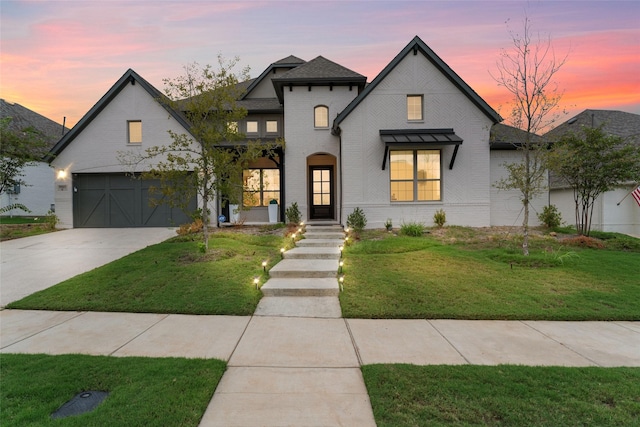 view of front of home featuring a lawn and a garage