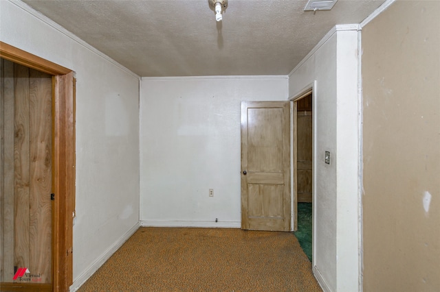 interior space with ornamental molding, a textured ceiling, and carpet floors