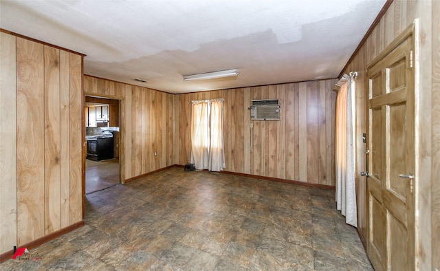 unfurnished room featuring an AC wall unit and wooden walls