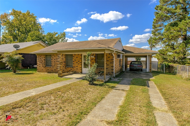 view of front facade featuring a front lawn, covered porch, and a carport