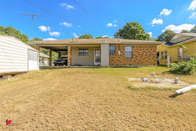 rear view of house with a yard and a carport