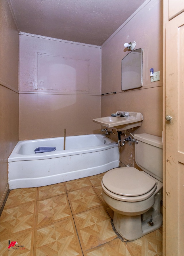 bathroom with a bathtub, toilet, parquet flooring, and ornamental molding