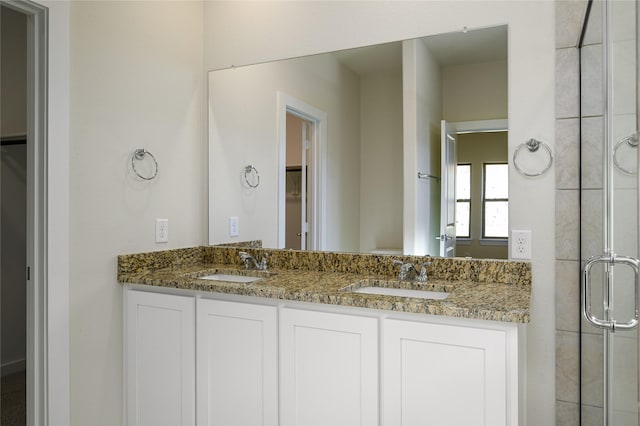 bathroom with an enclosed shower and vanity