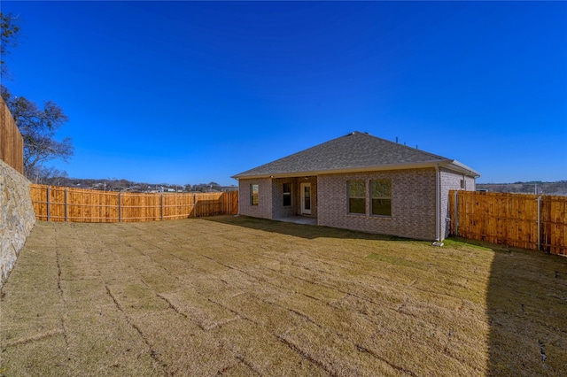 rear view of house with a lawn