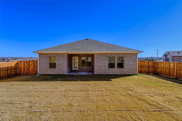 back of house featuring a yard and a patio