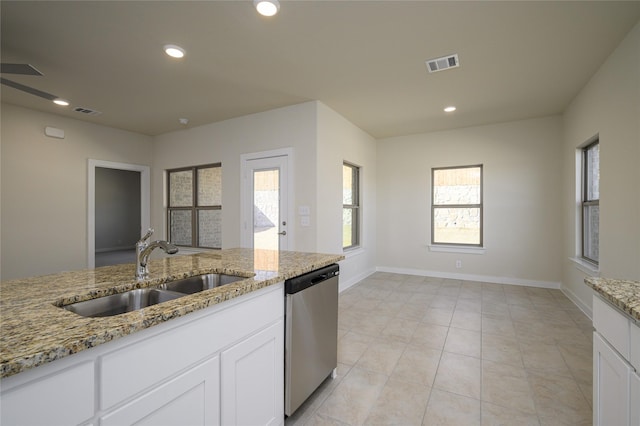 kitchen with light stone counters, sink, and dishwasher