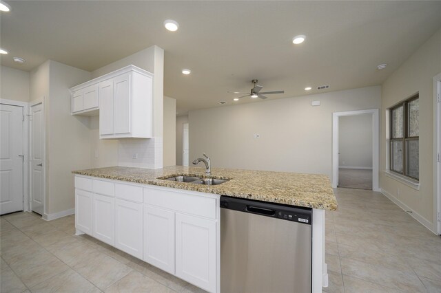 kitchen featuring light stone counters, sink, white cabinets, and dishwasher