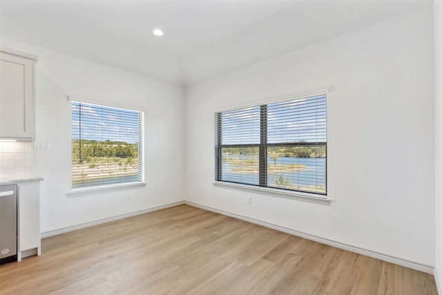 unfurnished dining area featuring light hardwood / wood-style flooring and plenty of natural light