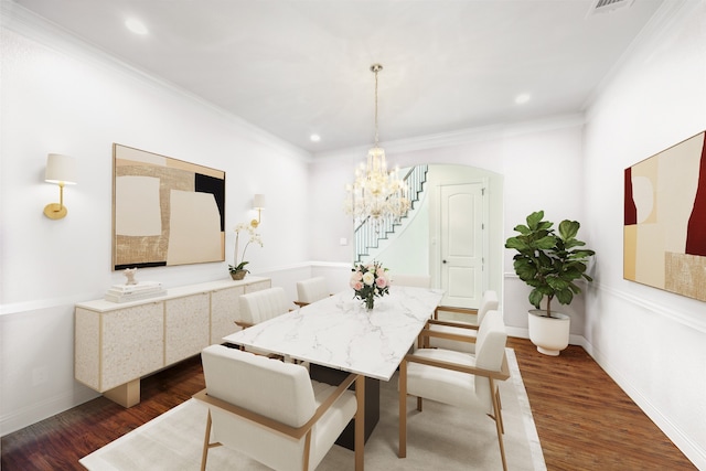 dining space with ornamental molding, dark hardwood / wood-style floors, and a chandelier