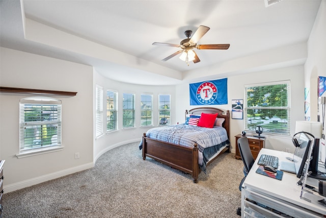 bedroom with multiple windows, light colored carpet, and ceiling fan