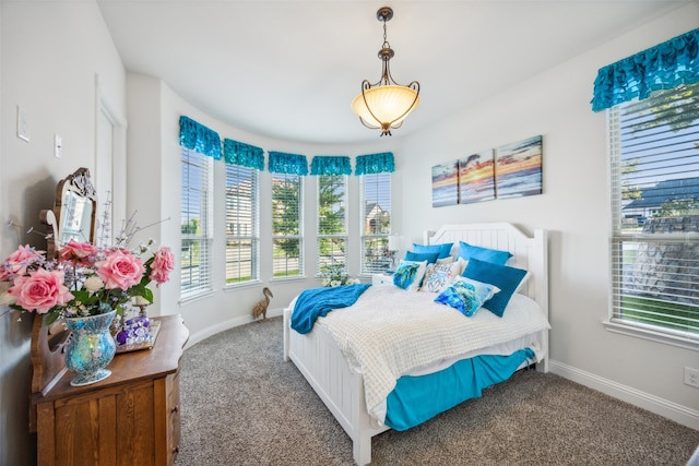 carpeted bedroom featuring multiple windows