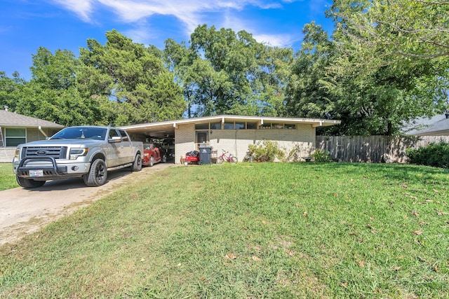 view of front facade with a front lawn and a carport