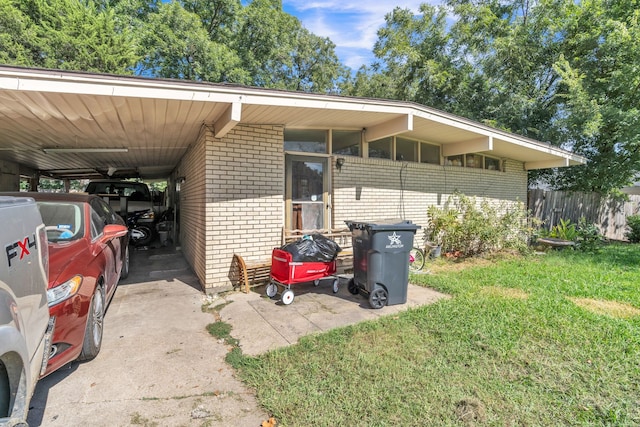 exterior space featuring a yard and a carport