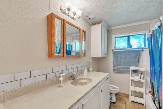 bathroom with a textured ceiling, tile patterned floors, crown molding, vanity, and toilet