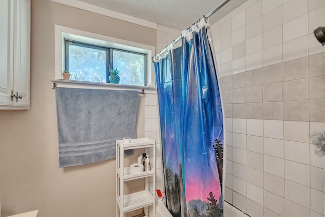 bathroom featuring shower / tub combo with curtain and a textured ceiling