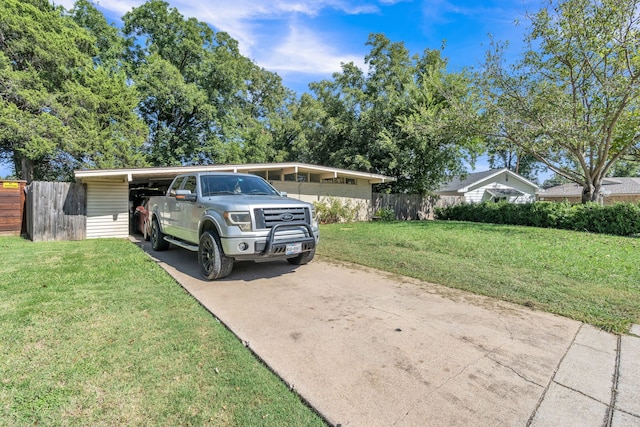 view of front of house with a front yard and a carport