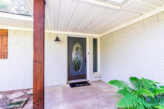 entrance to property with brick siding