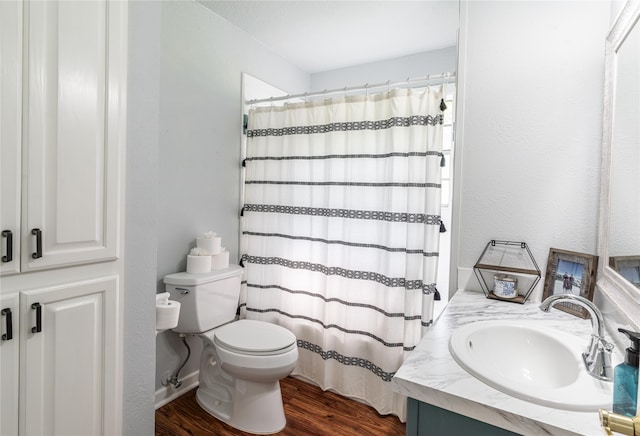 bathroom featuring hardwood / wood-style floors, toilet, a shower with shower curtain, and vanity