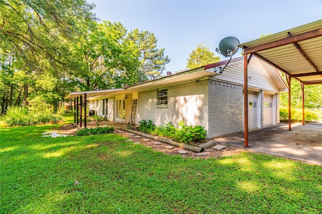 view of front of home with a garage, a front lawn, and a carport