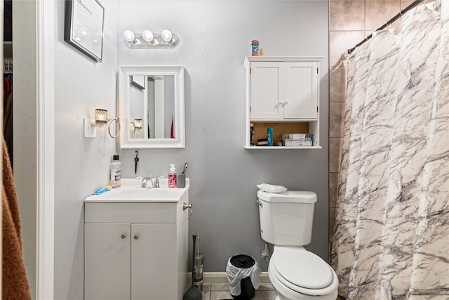 bathroom featuring toilet, vanity, tile patterned flooring, and walk in shower