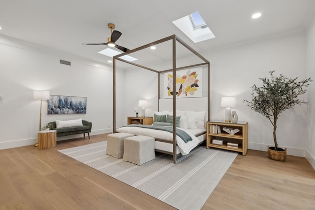 bedroom with ceiling fan, hardwood / wood-style flooring, and crown molding