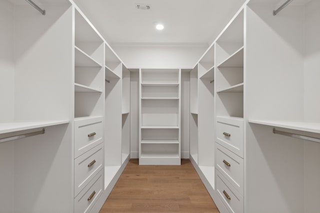 walk in closet featuring light hardwood / wood-style flooring