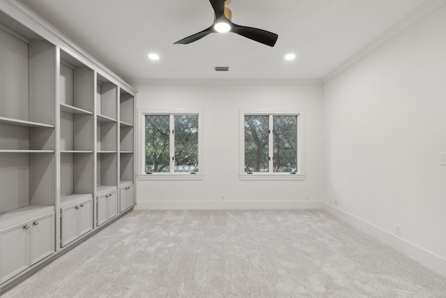 unfurnished room featuring ceiling fan, light colored carpet, and ornamental molding