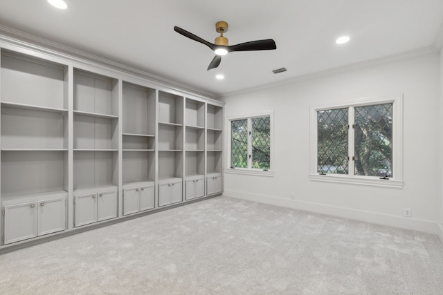 unfurnished bedroom with ceiling fan, crown molding, and light colored carpet