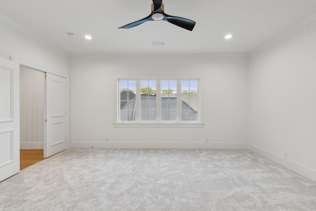 unfurnished bedroom with ceiling fan, light colored carpet, and ornamental molding