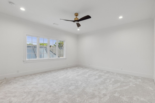 empty room with ceiling fan, carpet, and crown molding