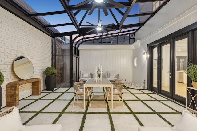 unfurnished sunroom featuring ceiling fan and french doors