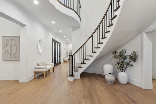 entrance foyer featuring crown molding and light wood-type flooring