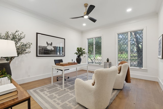 home office featuring a wealth of natural light, crown molding, and wood-type flooring