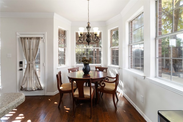 dining area with a chandelier, dark wood-type flooring, and crown molding