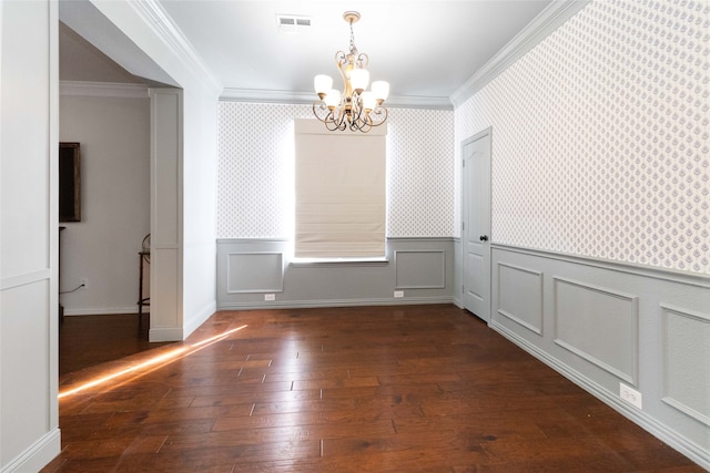 unfurnished dining area with ornamental molding, a chandelier, and dark hardwood / wood-style floors