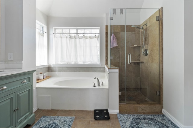 bathroom featuring plus walk in shower, tile patterned floors, and vanity