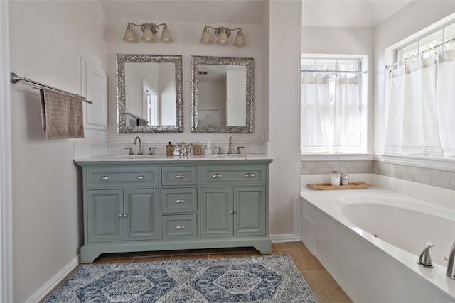 bathroom with vanity, tile patterned flooring, and a bath