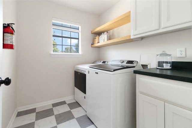 washroom featuring washer and clothes dryer and cabinets