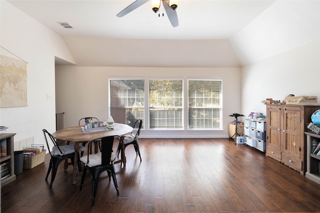 dining space featuring ceiling fan, vaulted ceiling, and dark hardwood / wood-style flooring