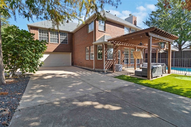 exterior space with a garage and a pergola