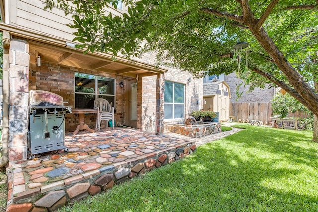 back of property with a lawn, a storage shed, and a patio area