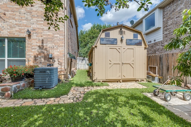 view of yard with cooling unit and a storage unit